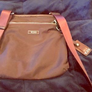 Tumi crossbody maroon bag.
